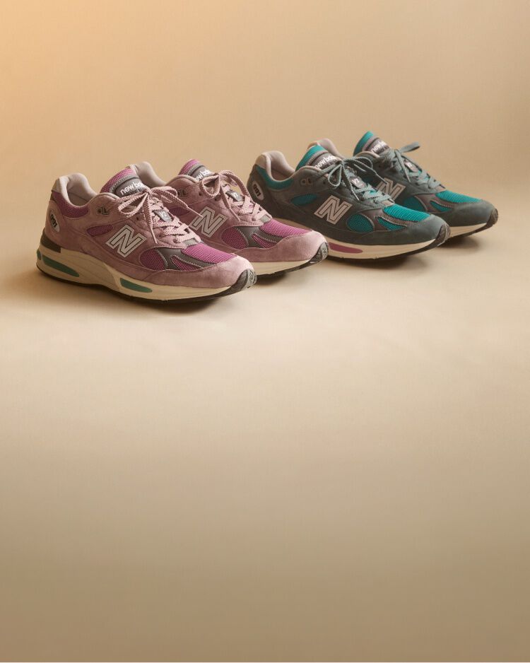 A pair of New Balance Made in UK sneakers sitting in a studio.