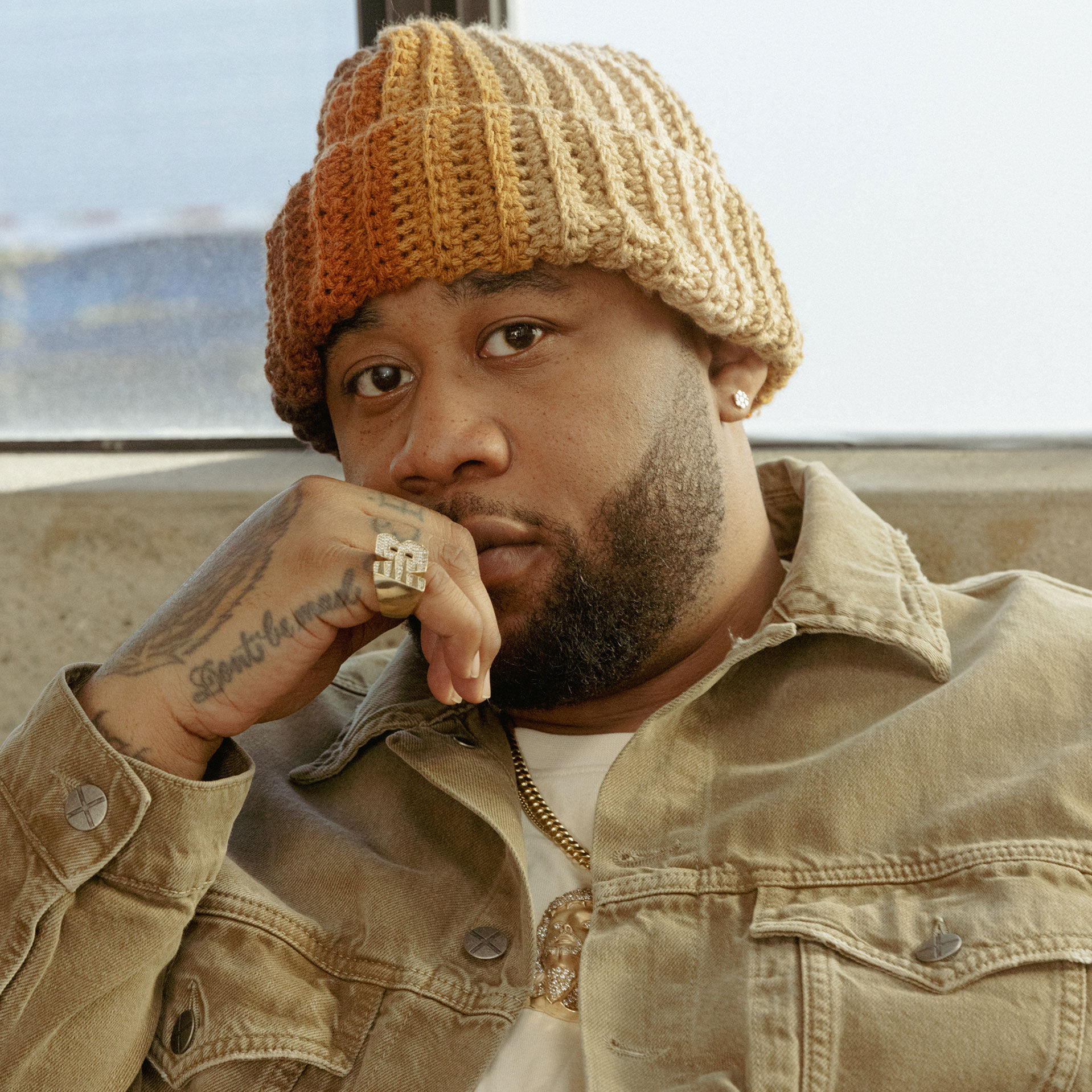 Close up image of Joe Freshgoods wearing a beanie and a denim jacket